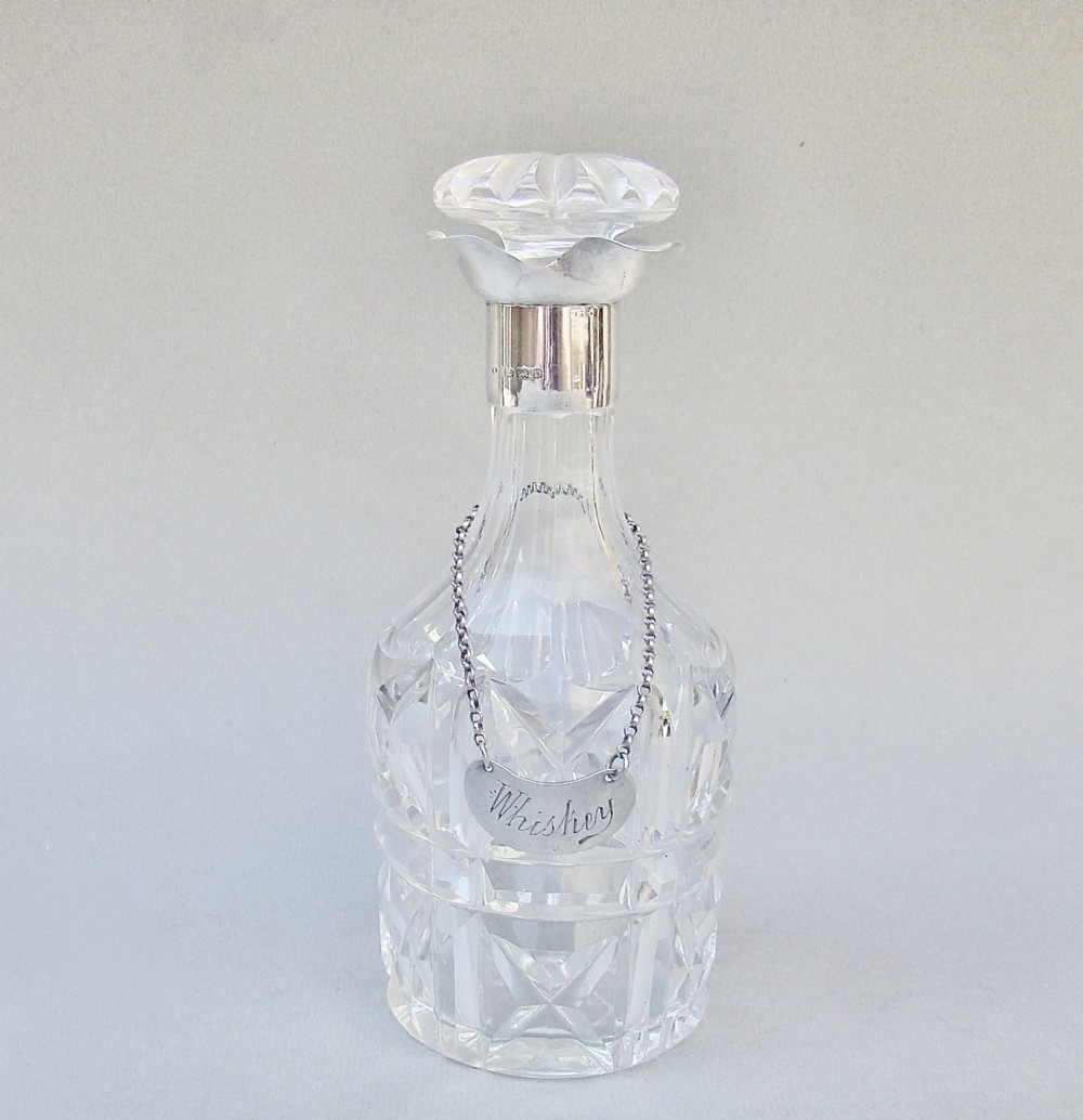 small art deco silver mounted glass decanter birmingham 1928 with edwardian silver whisky label london 1904