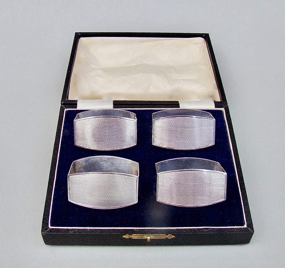 elegant cased set of four art deco solid silver napkin rings by fhadam co birmingham 1932