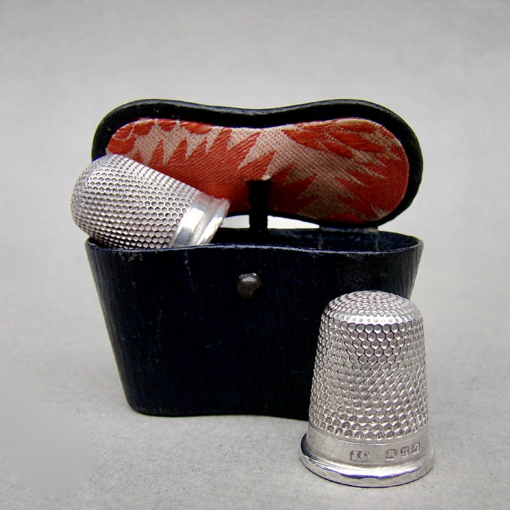 two victorian silver thimbles fitted in a novelty leather binocular case one thimble by charles horner chester 1894